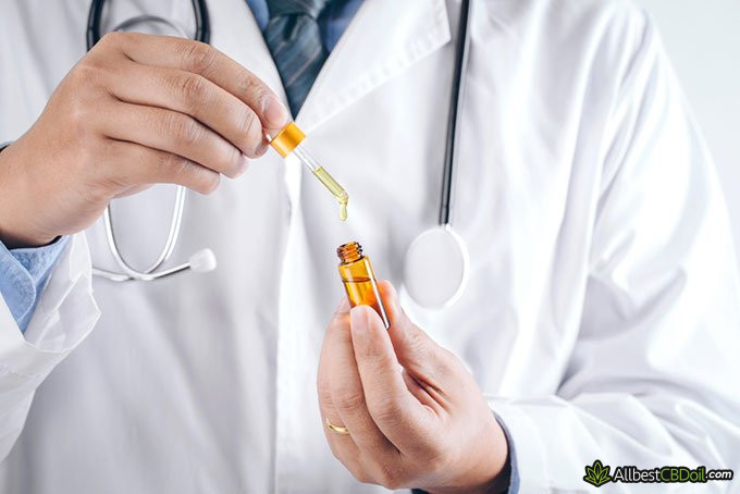 Does CBD get you high: doctor hold a bottle of CBD oil Does CBD get you high: doctor hold a bottle of CBD oil